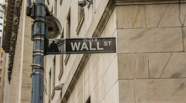 A Wall Street sign on a street pole