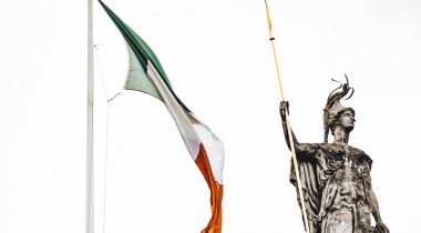 Irish flag next to statue of Lady Hibernia