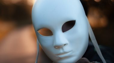 Photograph of a person holding a mask