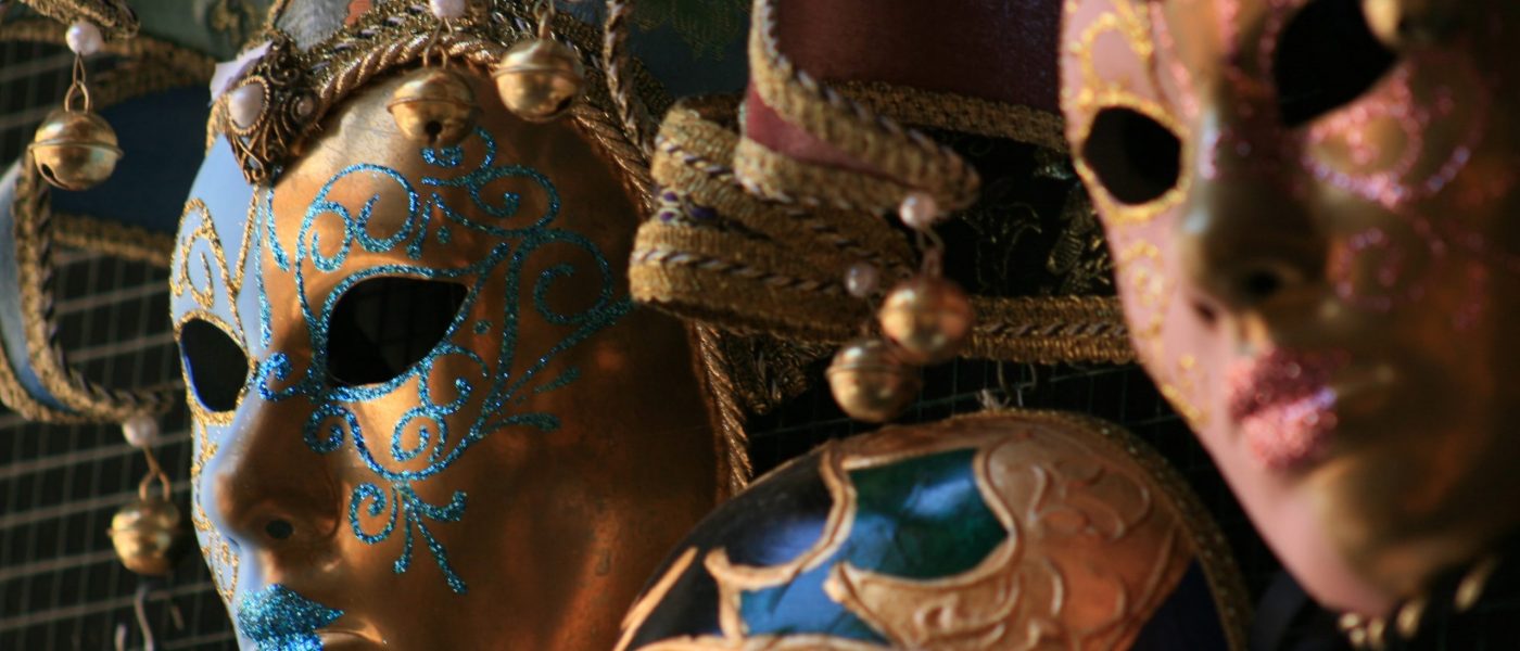 Close up image of two colourful costume masks