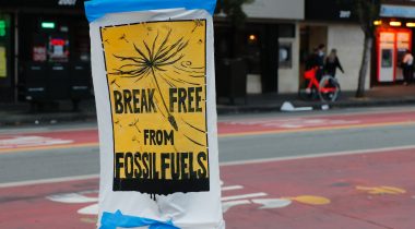 A sign on a lamppost that reads 'Break free from fossil fuels'