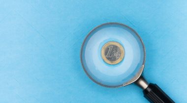 Magnifying glass above a coin