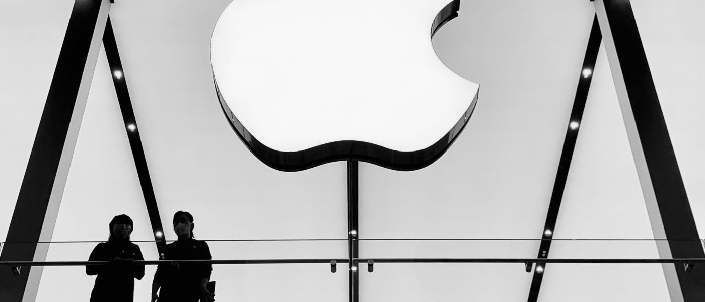A large Apple logo on a glass wall - UNSPLASH A large Apple logo on a glass wall