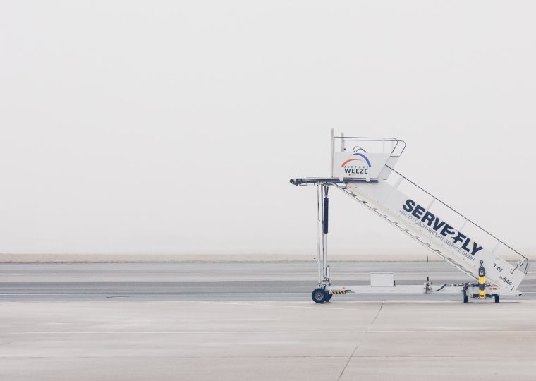 A stairs truck parked on an empty airport tarmac
