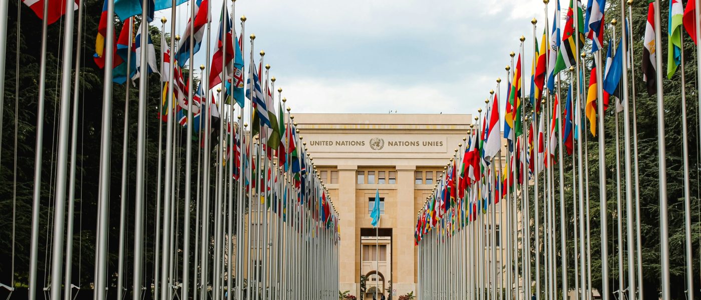 United Nations Office at Geneva – Photo by Mathias Reding United Nations building in Geneva with rows of international flags