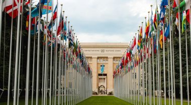 United Nations Office at Geneva – Photo by Mathias Reding United Nations building in Geneva with rows of international flags