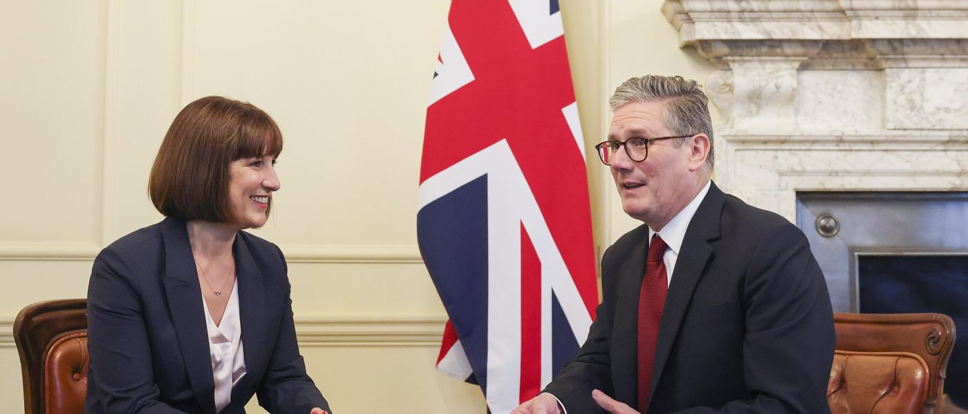 Chancellor Rachel Reeves and UK Prime Minster Starmer sitting at a table talking