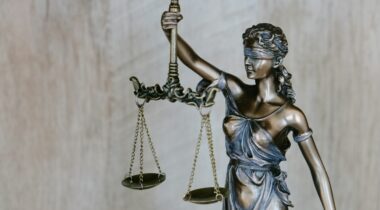 A statue of lady justice holding scales and a sword - UNSPLASH A statue of lady justice holding scales and a sword