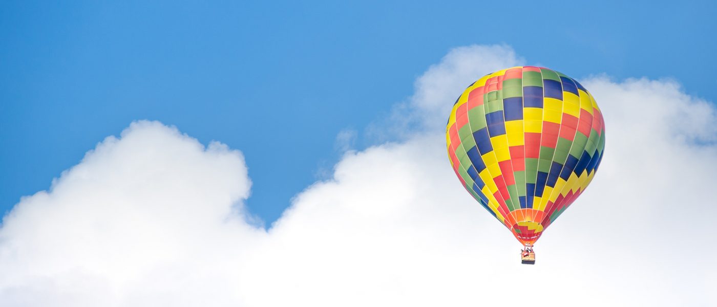 A hot air balloon in front of a blue sky