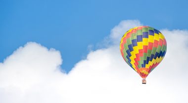 A hot air balloon in front of a blue sky