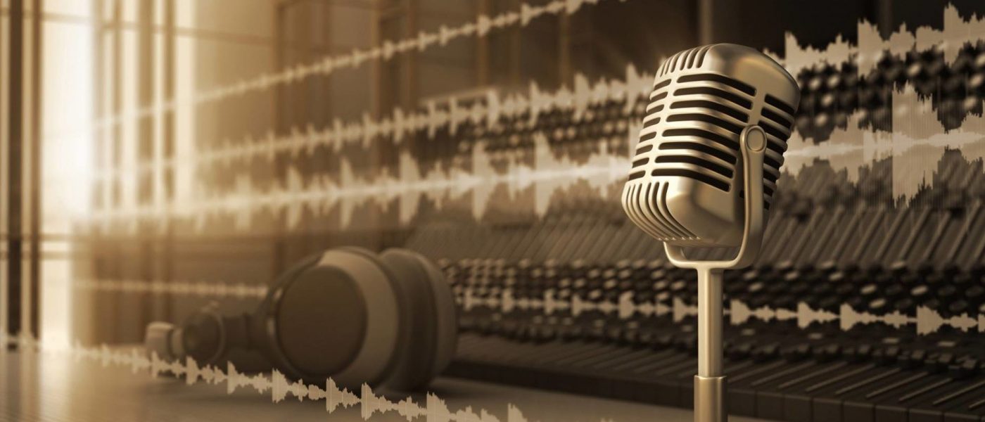 Podcast-microphone-large A silver microphone on a desk